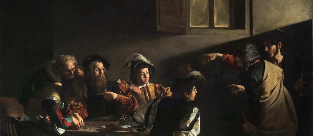 Five men sit around a table counting coins in a dim room. A shaft of light crosses the wall above them, following the pointing hand of Christ, who stands in shadow at the right. Only some of the men have looked up.